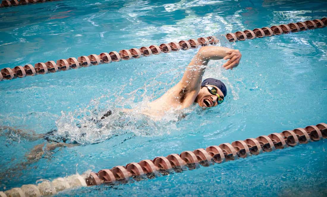 A swimmer competes in a freestyle race