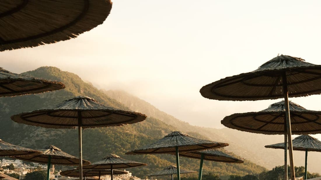 Beach umbrellas with a mountain backdrop