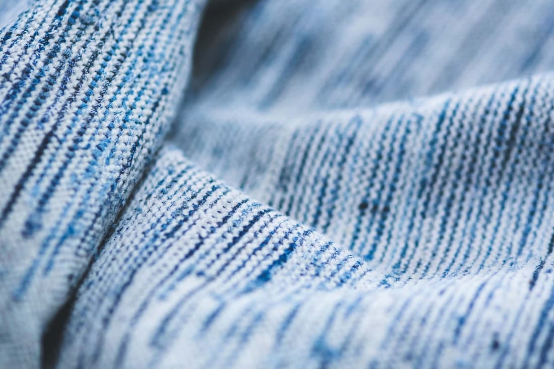Macro shot of a blue striped textile showing detailed texture and pattern